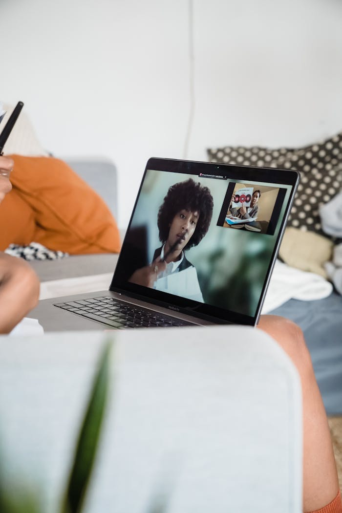 Close-up of a laptop screen during a video conference, showcasing remote work setup.